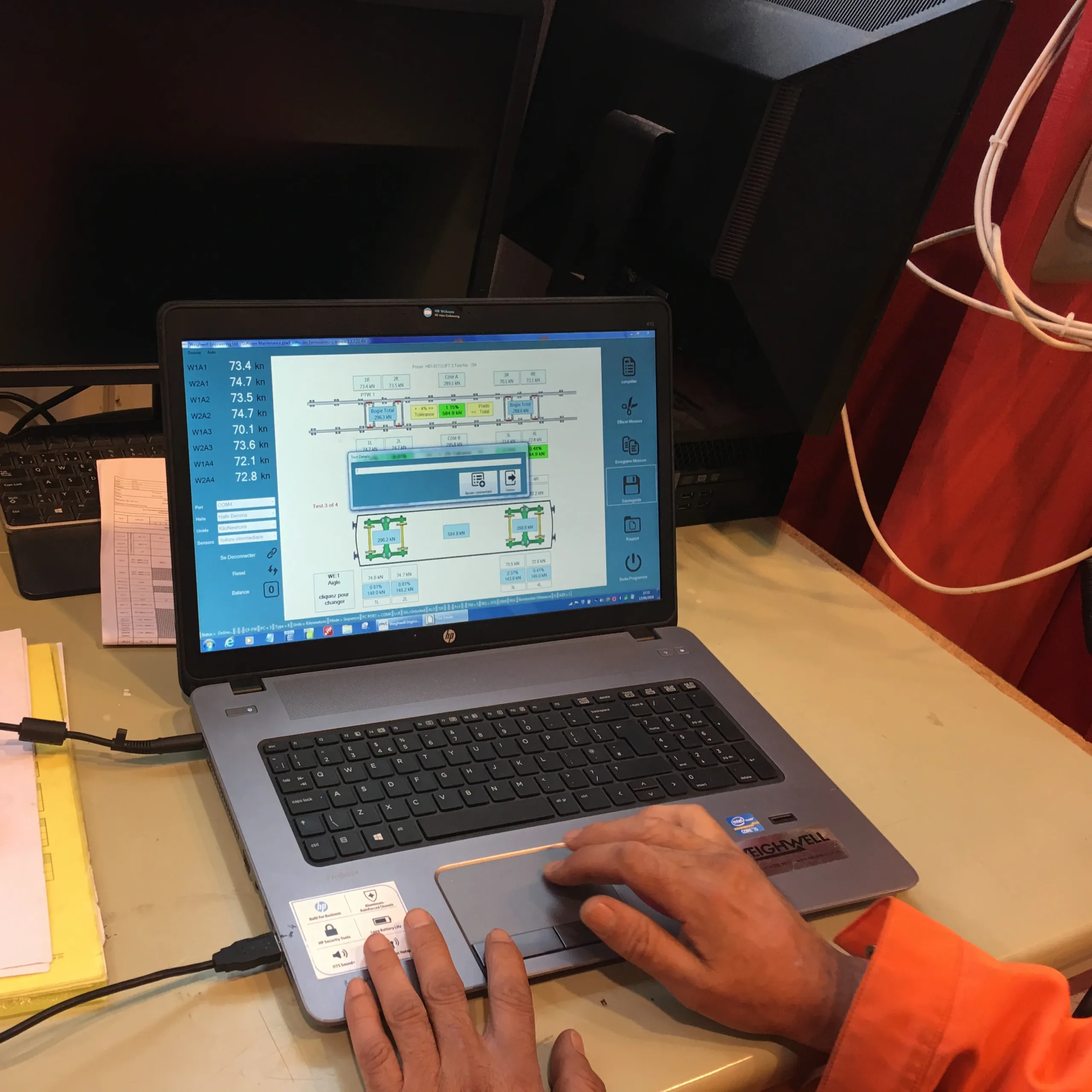 Technician using ptwX software on a laptop during railcar weighing Technician using ptwX software on a laptop during railcar weighing